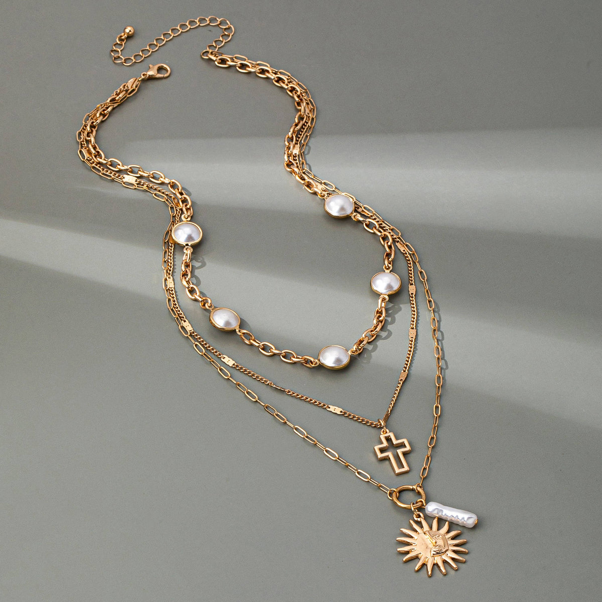 MULTI PEARL LAYER PEARL SUN CROSS CHARM NECKLACE | 80N92503