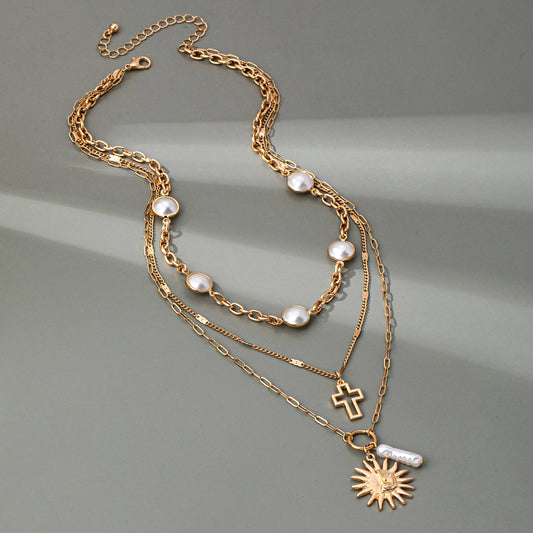 MULTI PEARL LAYER PEARL SUN CROSS CHARM NECKLACE | 80N92503