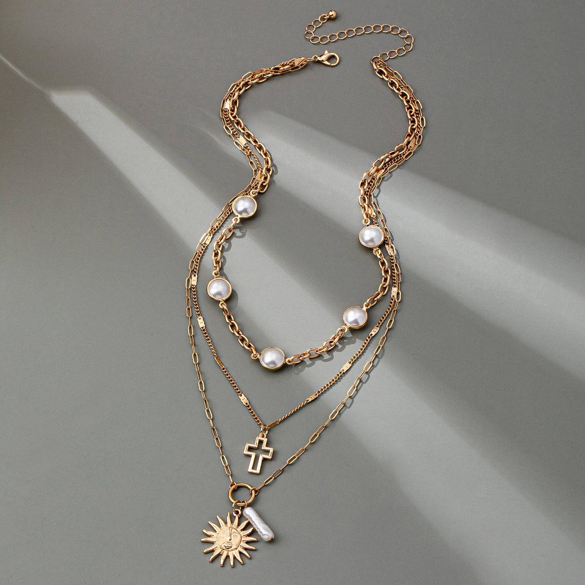 MULTI PEARL LAYER PEARL SUN CROSS CHARM NECKLACE | 80N92503