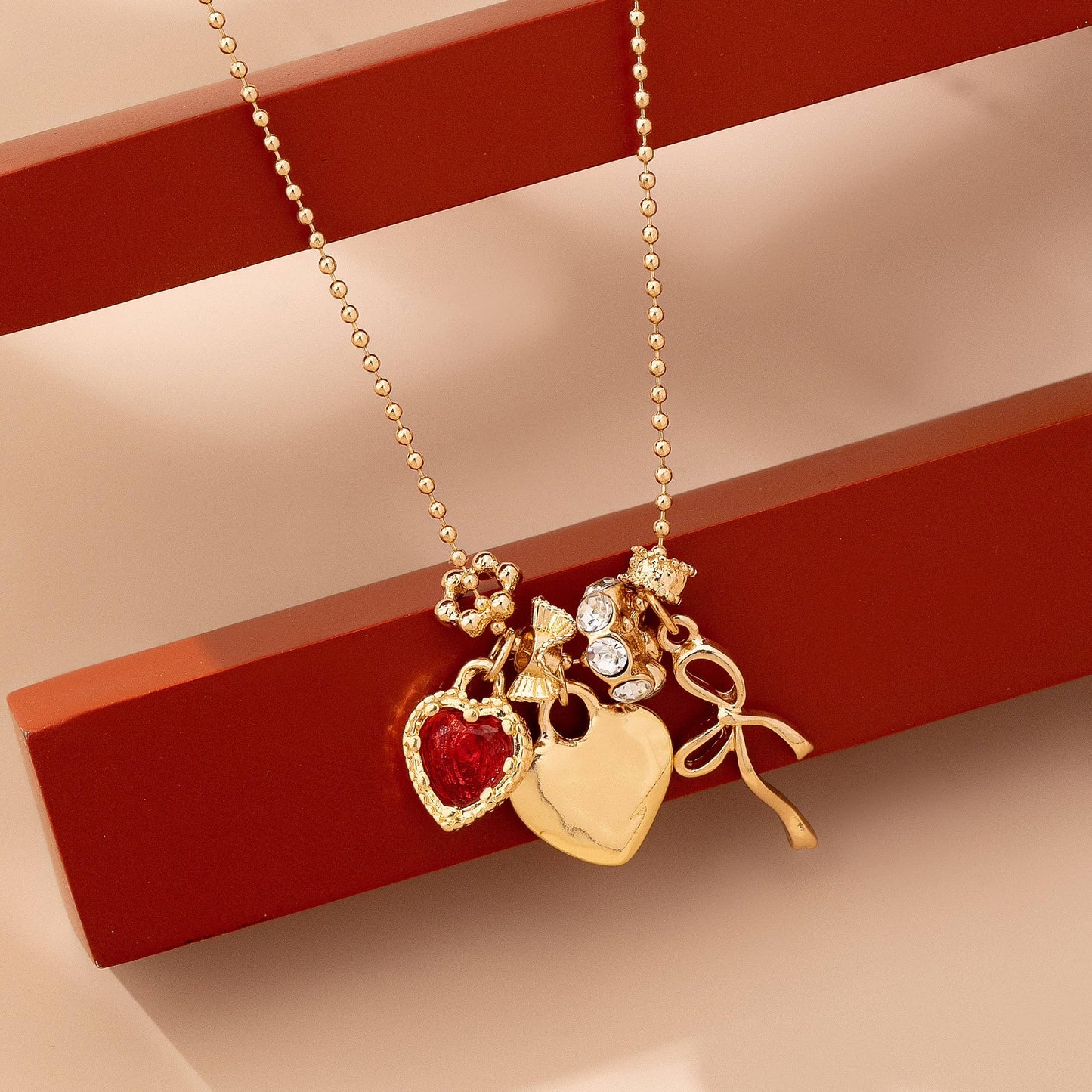 Multi-Charm Heart and Bow Necklace | 80N92882