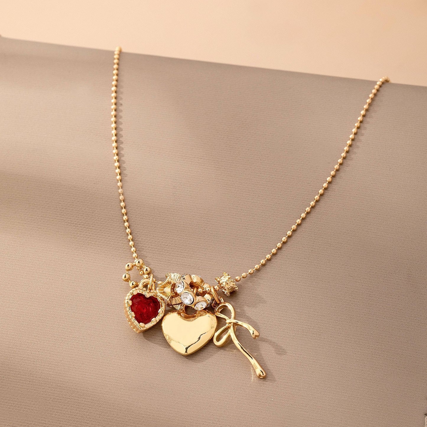 Multi-Charm Heart and Bow Necklace | 80N92882