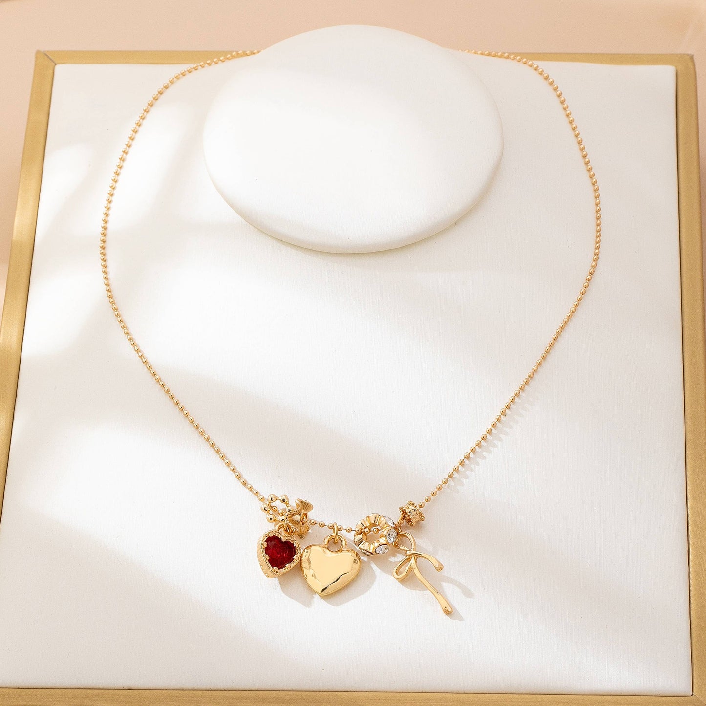 Multi-Charm Heart and Bow Necklace | 80N92882