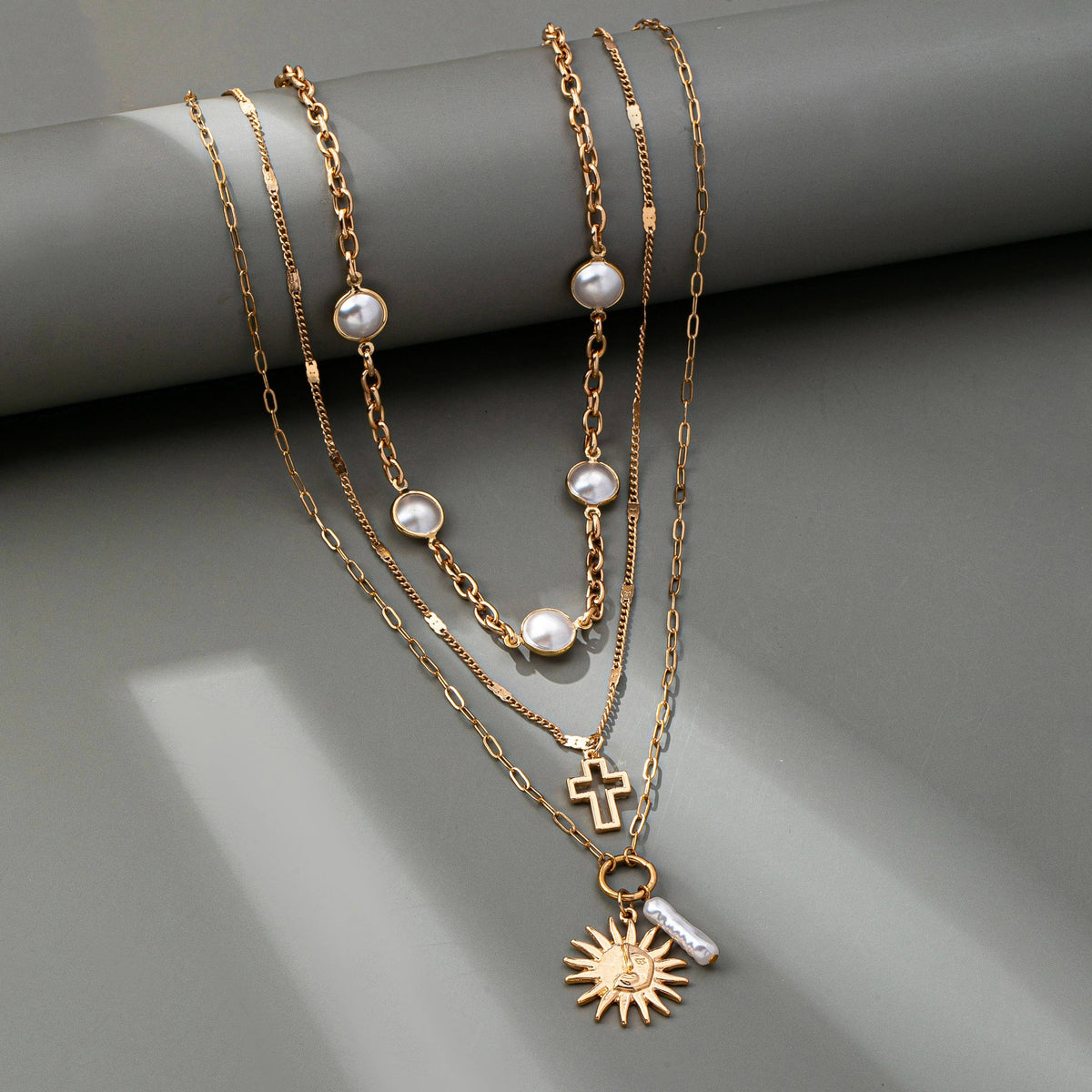 MULTI PEARL LAYER PEARL SUN CROSS CHARM NECKLACE | 80N92503