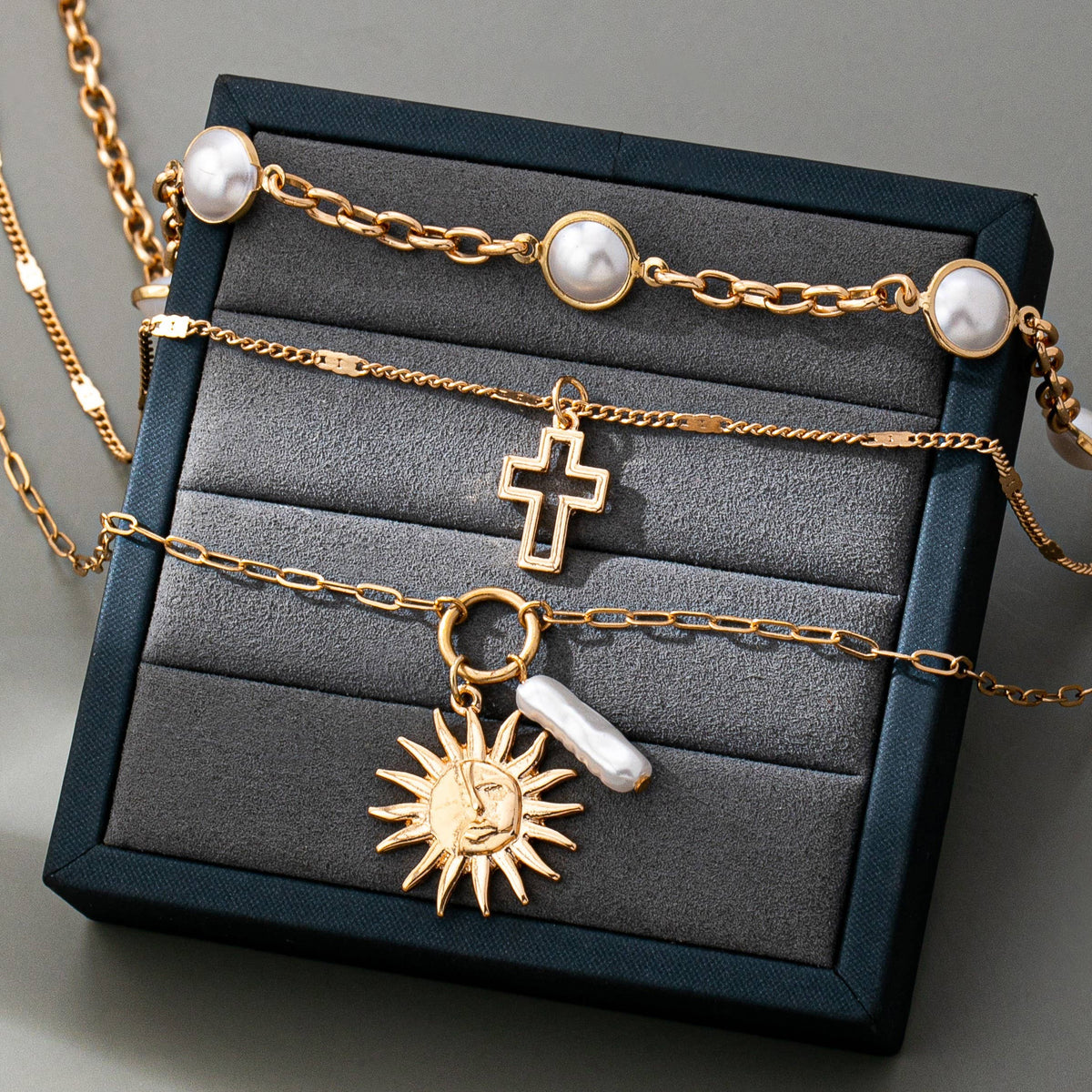 MULTI PEARL LAYER PEARL SUN CROSS CHARM NECKLACE | 80N92503