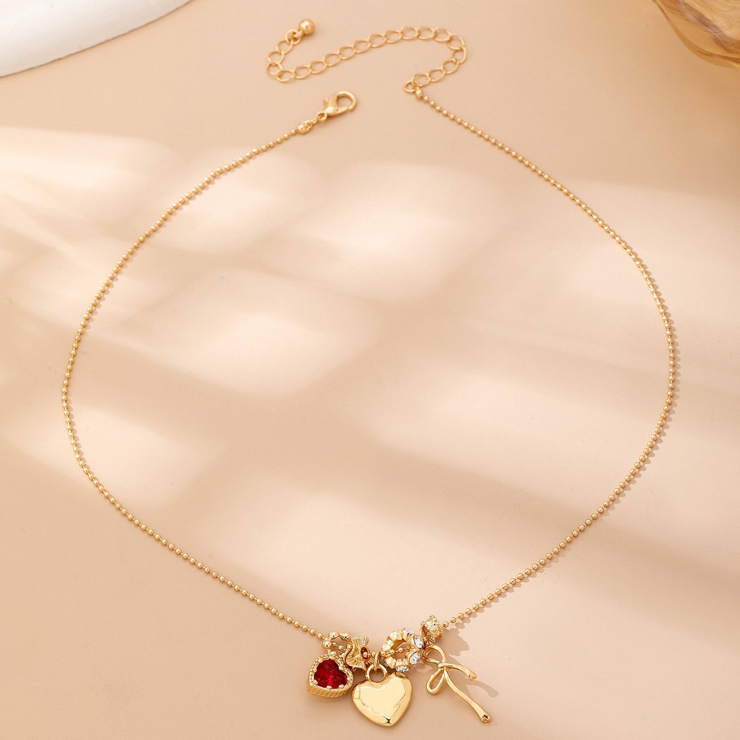 Multi-Charm Heart and Bow Necklace | 80N92882